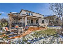 Backyard patio with pergola, outdoor seating and firepit on a sunny day at 2272 Front Range Rd, Erie, CO 80516