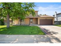 Charming two-story home with a well-maintained lawn and attached two car garage at 6240 W 110Th Pl, Westminster, CO 80020