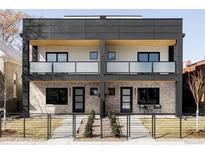 Modern exterior of a townhome with brick facade, black trim, and frosted glass balconies at 421 S Pearl St, Denver, CO 80209