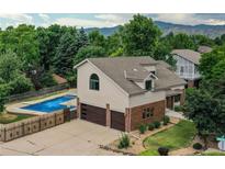 Charming home featuring a private pool, two-car garage, mature trees and mountain views at 8160 W Phillips Ave, Littleton, CO 80128