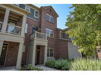 Inviting exterior view of a brick multi-story townhome with well-kept landscaping at 755 Roslyn St # 17, Denver, CO 80230