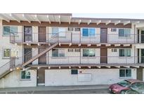 Apartment building exterior with stairways to the upper units and light-colored brick at 590 N Logan St # 303, Denver, CO 80203
