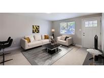 Bright living room featuring neutral walls, large window, stylish furniture, and modern decor at 4812 W 8Th Ave, Denver, CO 80204