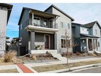 Charming two-story home with a red front door and cozy balcony at 1345 W 67Th Pl, Denver, CO 80221