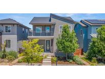 Two-story home with stylish architectural design, charming balcony, and well-maintained landscaping at 1345 W 67Th Pl, Denver, CO 80221