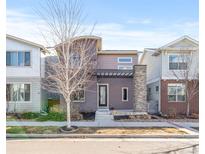 Modern two-story home with a stone pillar and pergola over the front entry at 6784 Navajo St, Denver, CO 80221