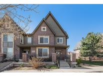 Charming townhome featuring a combination brick and siding exterior and manicured landscaping at 860 Bristle Pine Cir # A, Highlands Ranch, CO 80129