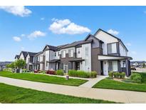 Beautiful townhomes with modern exteriors, lush landscaping, and inviting curb appeal at 19629 W 93Rd Dr # C, Arvada, CO 80007