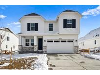 Beautiful two-story home featuring a two car garage, porch and well-manicured lawn at 39720 Congress Ln, Elizabeth, CO 80107