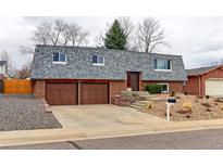 Charming brick home featuring a two-car garage and a well-maintained landscaped front yard at 10679 Union Way, Broomfield, CO 80021