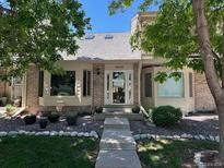 Charming single-Gathering home showcasing a well-maintained lawn and inviting entrance at 7624 S Cove Cir, Centennial, CO 80122