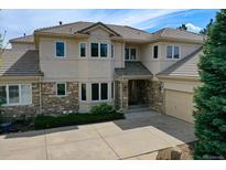 Beautiful home with a tile roof, stone accents, manicured landscaping and a large driveway at 13950 E Chenango Dr, Aurora, CO 80015
