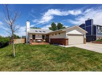 Charming single-Gathering home with a well-maintained lawn and a cozy front deck at 11883 W Marlowe Pl, Morrison, CO 80465
