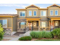 Charming townhome with stone accents, landscaped front yard, and cozy porch at 5562 W 72Nd Pl, Westminster, CO 80003