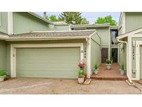 Charming townhome with a two-car garage and a well-manicured front yard, ready for its new owners at 2840 S Kenton Ct, Aurora, CO 80014