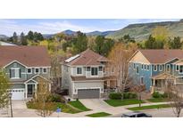Two-story home with well-manicured lawn and mountain views, including solar panels at 15960 W 62Nd Dr, Arvada, CO 80403