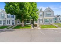 Charming townhouse complex with well-maintained landscaping and a large tree in front at 10814 Bayfield Way, Parker, CO 80138
