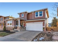 Two-story house with a large garage and stone accents at 10778 Mountshire Cir, Highlands Ranch, CO 80126