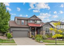Charming two-story home showcasing inviting curb appeal with a manicured lawn and lovely landscaping at 11961 S Saunter Ln, Parker, CO 80138