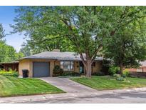 Ranch style home with mature landscaping and attached garage at 2872 S Zenobia St, Denver, CO 80236