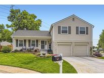 Charming two-story home with a well-manicured lawn, complemented by a two-car garage and tasteful landscaping at 7465 S Ivy Way, Centennial, CO 80112