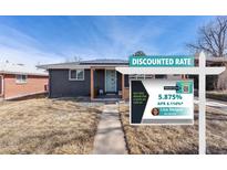Charming home featuring solar panels, a welcoming front porch, and professional real estate signage at 1742 S Alcott St, Denver, CO 80219