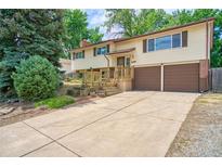 Charming two-story home features a well-maintained yard, brick accents, and a two-car garage at 1209 S Terry St, Longmont, CO 80501