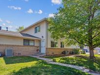 Charming townhome with well-maintained lawn and mature tree providing shade at 3351 S Field St, Lakewood, CO 80227