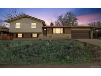 Charming two-story home with brick and vinyl siding, inviting curb appeal, and an attached two car garage at 12931 E 46Th Ave, Denver, CO 80239