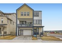 Modern three-story home with a two-car garage, second-floor balcony, and inviting curb appeal at 7321 Waterleaf Trl, Littleton, CO 80125