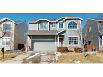 Two-story home with gray siding, attached two-car garage, and manicured front yard at 9649 Lansing Cir, Commerce City, CO 80022