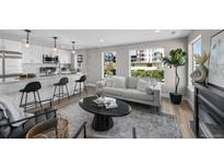Bright living space featuring a modern kitchen, comfortable seating, and natural light from large windows at 2140 S Ash St # 101, Denver, CO 80222