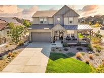 Charming two-story home with a well-maintained lawn and a covered front porch at 8378 Arapahoe Peak St, Littleton, CO 80125