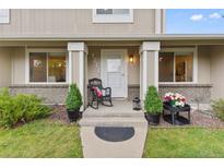 Inviting front porch with a rocking chair and decorative plants at 4650 S Idalia St, Aurora, CO 80015