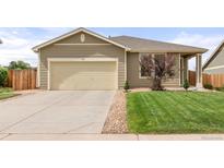 Inviting single-story home featuring a well-kept lawn, concrete driveway, and attached two-car garage at 848 Sagebrush Dr, Brighton, CO 80603