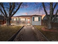 Charming single-Gathering home with inviting front porch, walkway, rock garden, and mature trees at 1927 Kenton St, Aurora, CO 80010