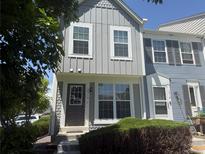 Charming townhome featuring a gray exterior, a front door, and manicured landscaping at 10716 Foxwood Ct, Parker, CO 80138