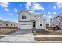 Charming two-story home with a two-car garage and a well-manicured front yard under a cloudy sky at 849 Alpine Ridge St, Erie, CO 80516