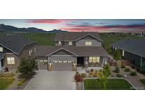 Charming two-story home with mountain views, well-manicured lawn, and welcoming front porch at 8803 Antero Ct, Arvada, CO 80007