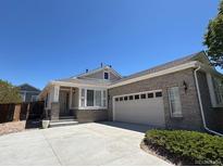 Charming single-story home with a well-manicured lawn and a paved driveway leading to an attached two-car garage at 20148 E Dartmouth Dr, Aurora, CO 80013