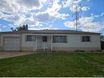 Charming single-story home with well-maintained lawn and front porch at 3905 Nelson St, Wheat Ridge, CO 80033