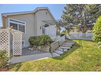 Well-maintained backyard featuring a patio, lush lawn, and landscaping, offering a serene outdoor space at 2265 S Depew St, Denver, CO 80227