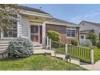 Charming brick home with a well-manicured front yard and inviting entrance at 2265 S Depew St, Denver, CO 80227