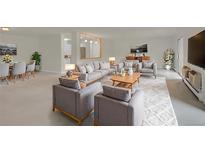 Bright living room with modern gray sofas, wood accents, and stylish decor offers comfortable seating and living space at 3144 S Wheeling Way # 206, Aurora, CO 80014