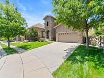 Charming two-story home with stone accents, manicured lawn, and a spacious driveway at 13645 Osage Ct, Broomfield, CO 80023