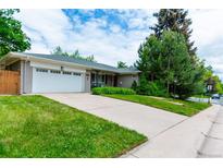 Charming ranch home with an attached two-car garage and mature landscaping in a quiet, residential neighborhood at 3098 S Vine St, Denver, CO 80210