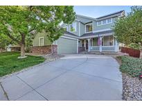 Charming two-story home with a covered front porch and an extended driveway at 2865 S Yampa Way, Aurora, CO 80013