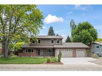 Charming two-story home with a manicured lawn, complemented by a three car garage and classic exterior at 7409 Mount Meeker Rd, Longmont, CO 80503