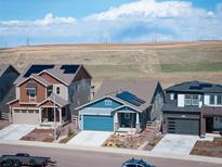 Modern homes with solar panels line a sunny street, showcasing energy efficiency and contemporary design at 8346 Mount Kataka St, Littleton, CO 80125