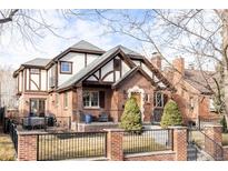 Brick home with a classic design, landscaped yard, and a brick fence at 1275 S Elizabeth St, Denver, CO 80210